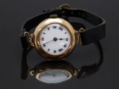 Swiss 15ct gold ladies wristwatch with blued hands, Roman numerals, white enamel dial and unsigned