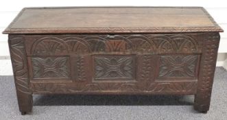 A 17th/18thC oak coffer with carved decoration, W107 x D37 x H53cm