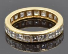 French 18ct gold eternity ring set with 21 square step cut diamonds' each approximately 0.15ct,