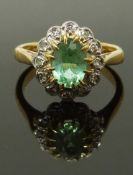 An 18ct gold ring set with a tourmaline and diamonds, size G, 3.24g