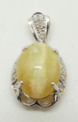 A 9ct white gold pendant set with an oval cat's eye opal cabochon and diamonds, 4.4g
