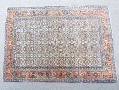 Persian rug with all over boteh design on a cream ground surrounded by a floral motif border, 197