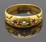 An 18ct gold ring set with a diamond and rubies in a G.W.Harvey Wellington box, size O, 2.87g