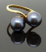 A 9ct gold ring set with two Tahitian black pearls, size O, 3.49g
