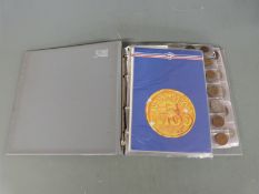 An amateur collection of world coins in an album, all small coinage