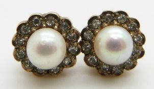 A pair of 9ct gold earrings set with a pearl surrounded by diamonds, 2.2g