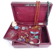 A collection of jewellery including a dragonfly brooch, malachite beaded necklace, amber necklace,