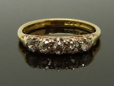 An 18ct gold ring set with five diamonds, size K, 2.55g