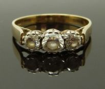 A 9ct gold ring set with three cubic zirconia, size O, 2.28g