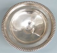 White metal pedestal tazza with pierced and embossed decoration, marked Empire Sterling weighted,