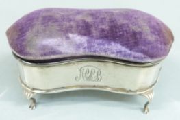 George V hallmarked silver jewellery box with shaped lid, padded lid and raised on four feet,