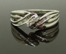 A 9ct white gold ring set with round and baguette cut diamonds, size O, 2.60g