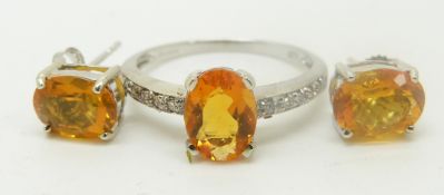 A 9ct white gold ring set with an oval cut fire opal and diamonds and a pair of 9ct gold earrings