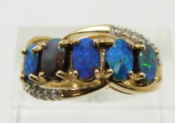 A 9ct gold ring set with five boulder opals and zircons, 4.7g, size N