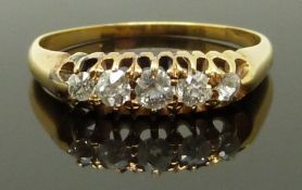 An 18ct gold ring set with five diamonds, size L, 2.69g