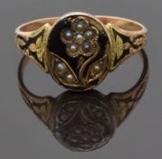 Victorian mourning ring set with seed pearls in the form of a flower on black enamel ground and with