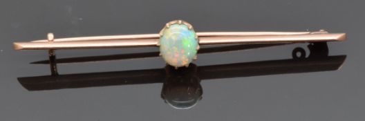 A late Victorian/ early Edwardian 9ct rose gold brooch set with an opal cabochon, 3.2g