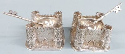 Carrington & Co George V pair of novelty hallmarked silver salts formed as castles, the spoons