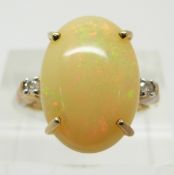 A 9ct gold ring set with a large opal cabochon and diamonds, 3.6g, size O