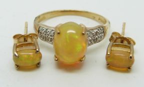 A 9ct gold ring set with an oval opal cabochon and diamonds (size N) with a pair of similar earrings