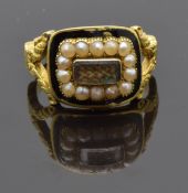 An 18ct gold mourning ring set with plaited hair, seed pearls and black enamel, with engraved