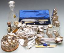 A collection of plated ware including a wine coaster, fish servers, grape scissors, cutlery,
