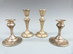 Two pairs of hallmarked silver candlesticks, one pair Birmingham 1957 the other 1945, height of