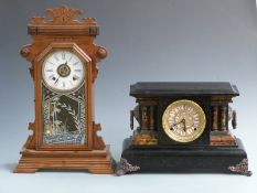 A 19thC American gingerbread clock with Roman dial and alarm feature, 56cm tall together with a faux