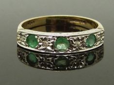 A 9ct gold ring set with emeralds and diamonds in a platinum setting, size I/J, 1.57g