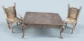 Victorian novelty hallmarked silver doll's house table and two chairs, the table having embossed