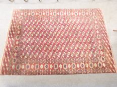 Turkoman rug with gul filled central field on a wine ground, 322 x 224cm
