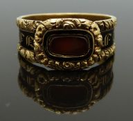 Georgian 18ct gold mourning ring set with a glass compartment surrounded by black enamel and foliate