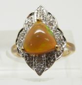 A 9ct gold ring set with a Kalimaya trilliant cut opal surrounded by white sapphires, 5.1g, size M