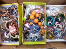 A collection of costume jewellery including beaded necklaces, bangles, brooches, etc