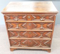 An antique oak chest of two over three graduated drawers with shaped drawer fronts, drop handles and