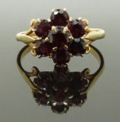 A 9ct gold cluster ring set with a cluster of garnets, size R, 3.00g