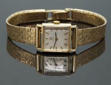 Omega 9ct gold ladies wristwatch ref. 511.5179 with black hands, gold hour markers, silver dial,