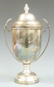 Large hallmarked silver twin handled lidded trophy cup, Birmingham 1966 maker's mark rubbed,