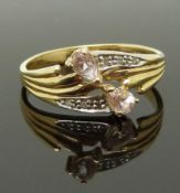 A 9ct gold ring set with two pear cut morganite and diamonds, size M/N, 1.84g
