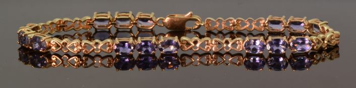 A 9ct gold tennis bracelet set with oval cut tanzanites, 19.5cm, 8.8g