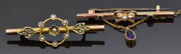 A 9ct gold brooch set with amethysts and a seed pearl with a further suspended pear cut amethyst and