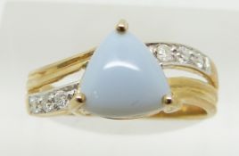 A 9ct gold ring set with a trilliant cut blue fire opal cabochon and diamonds, 2.5g, size N