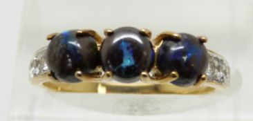 A 9ct gold ring set with three round boulder opal cabochons and white sapphires, 2.3g, size N