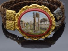 A 19thC micro mosaic mourning bracelet of two strands of plaited hair holding a central micro mosaic