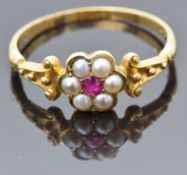 Victorian 18ct gold ring set with a ruby surrounded by split pearls, size R