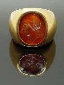 A yellow metal ring set with a carnelian agate intaglio, size M/N, 18.10g