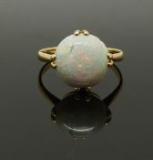 A yellow metal ring set with a round opal cabochon, 2g, size H/I