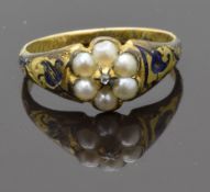 Victorian mourning ring set with a diamond surrounded by split pearls and enamel to the shoulders