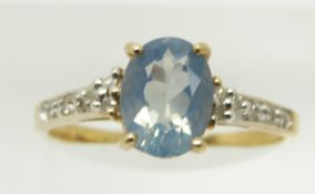 A 9ct gold ring set with an oval blue fire opal and diamonds, 1.8g, size N