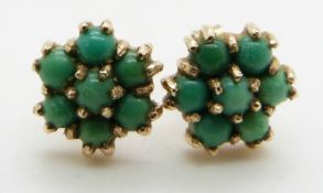 A pair of 9ct gold earrings set with turquoise cabochons in a cluster, 2.5g